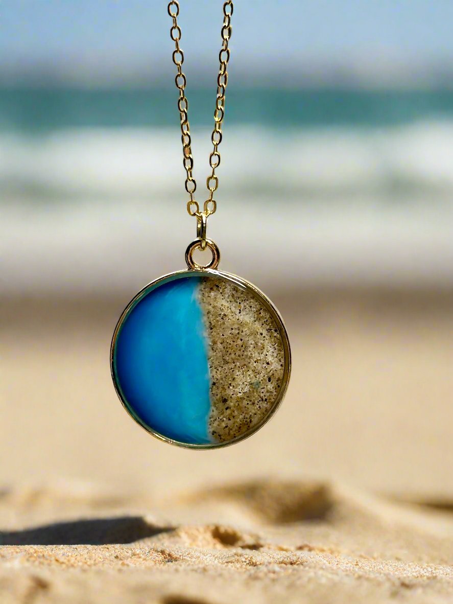 This is a photo of a pendant necklace representing the coast of Carpinteria.