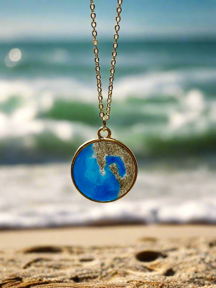 This is a pendant necklace. A gold pendant and inside real California sand and resin representing the coast of San Diego.