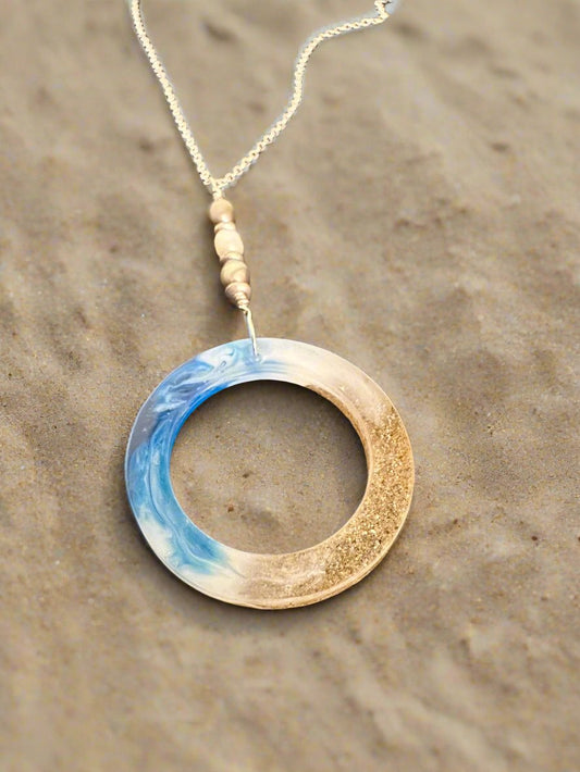 This is a photo of the resin and sand open circle necklace.