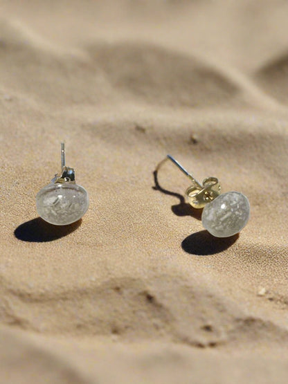 This is a side view of the white seashell and resin button earrings.